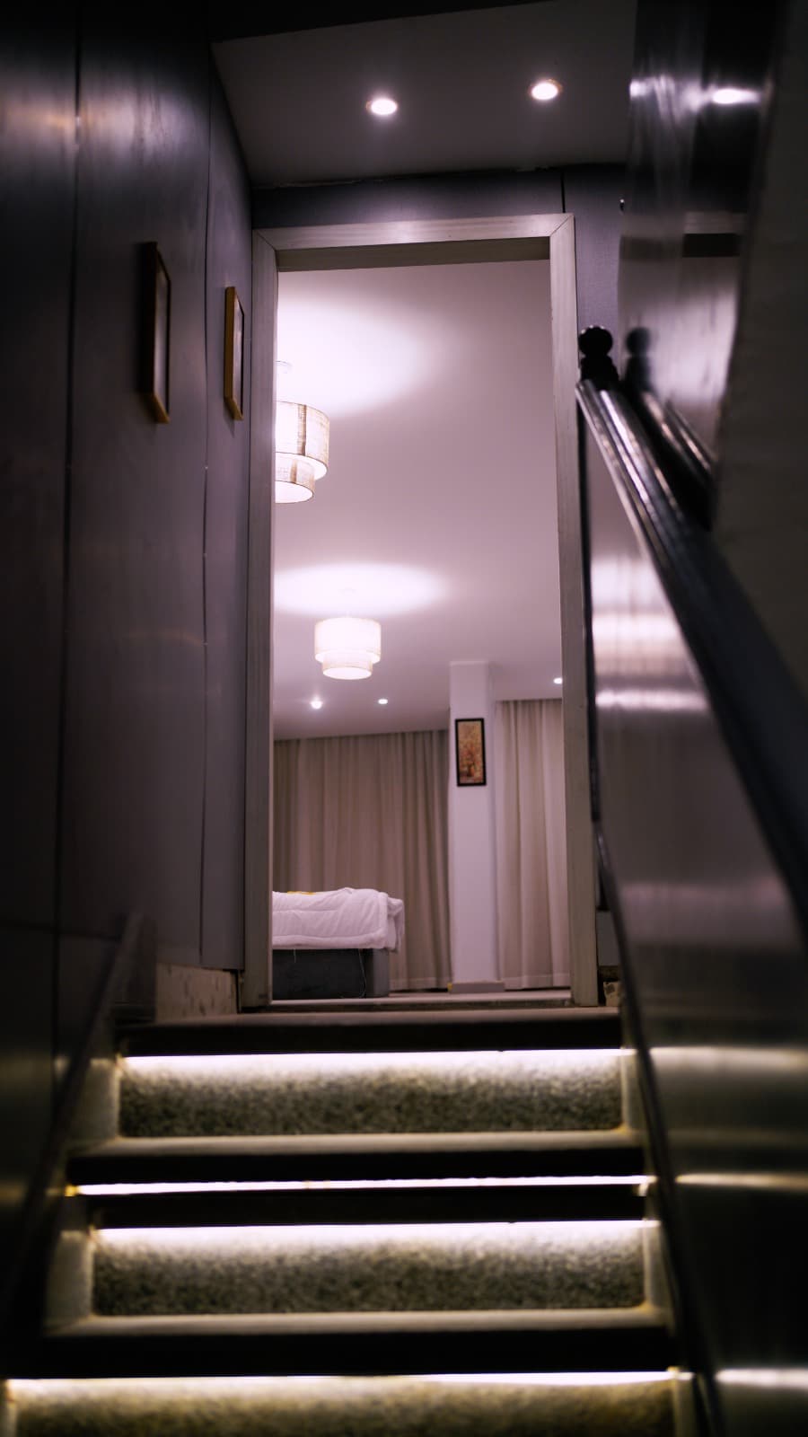 Pendant lamp casting warm light in suite